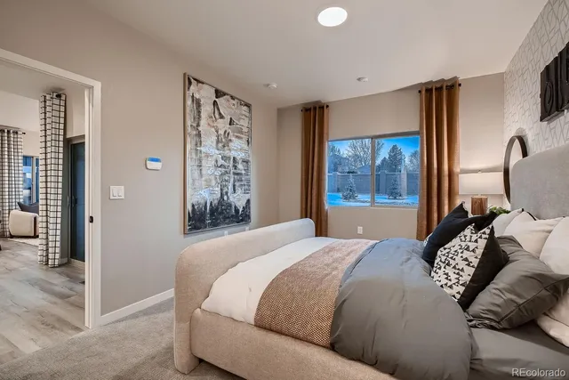 a bedroom with a large bed and a window