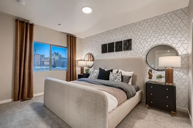 a bedroom with a large bed and a mirror