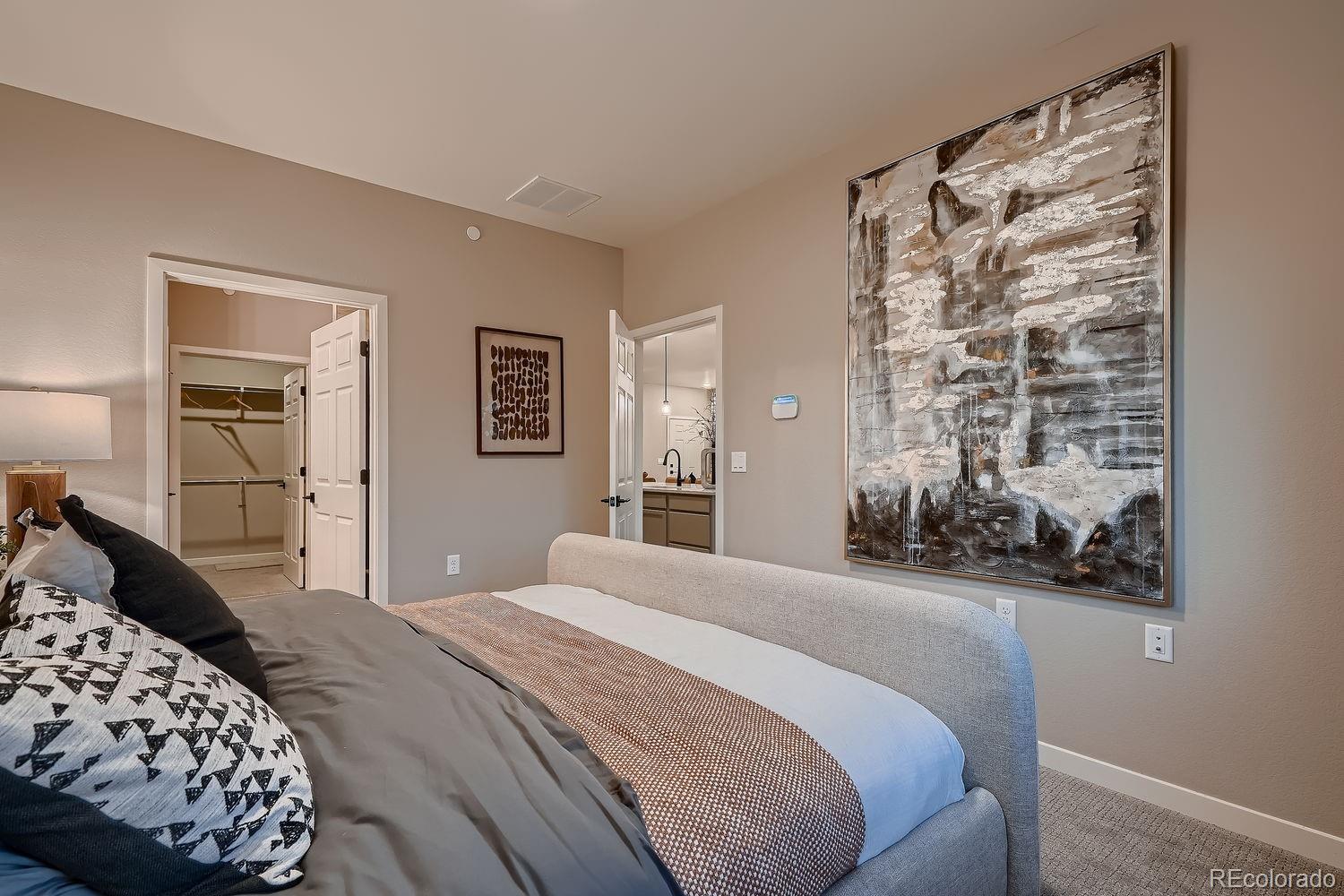 12880 Inca Street Westminster, CO 80234 - Photo 34 of 50 a bedroom with a bed and a painting on the wall