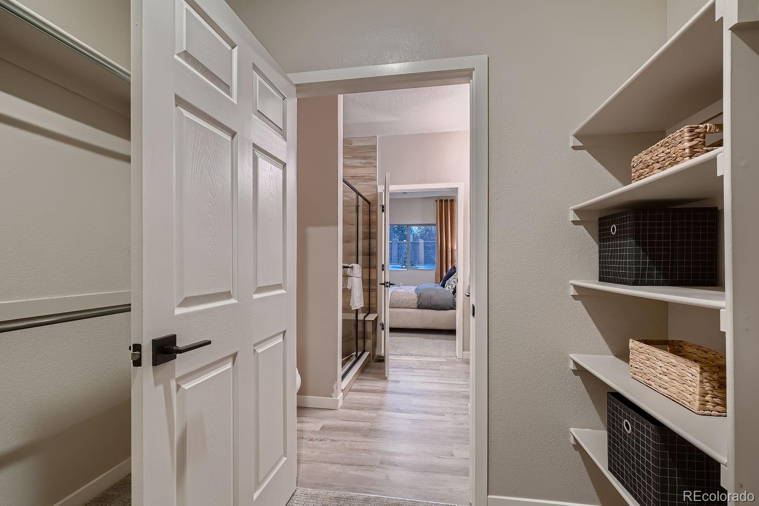 12880 Inca Street Westminster, CO 80234 - Photo 38 of 50 a view of a hallway and a livingroom with a chair