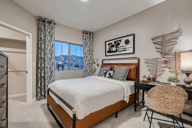 a bedroom with a bed and painting on the wall