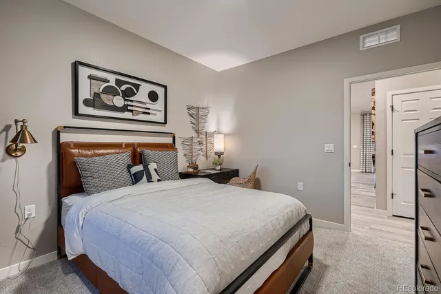 a bedroom with a bed and a dresser