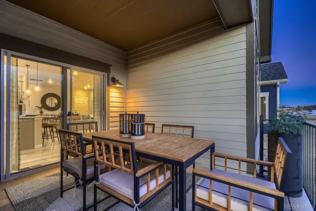 a view of a roof deck with table and chairs