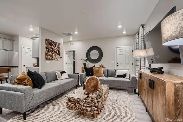 a living room with furniture a rug and a fireplace