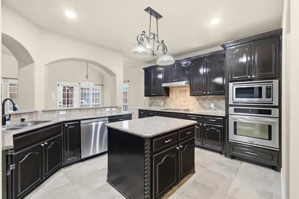 a kitchen with a stove sink and microwave