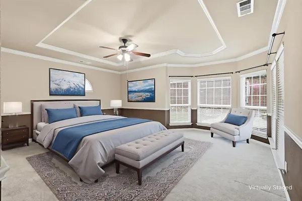 a spacious bedroom with a bed couch and a large window