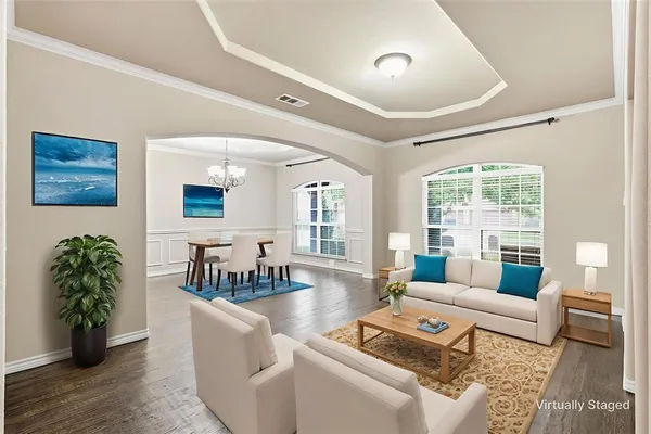 a living room with furniture and wooden floor
