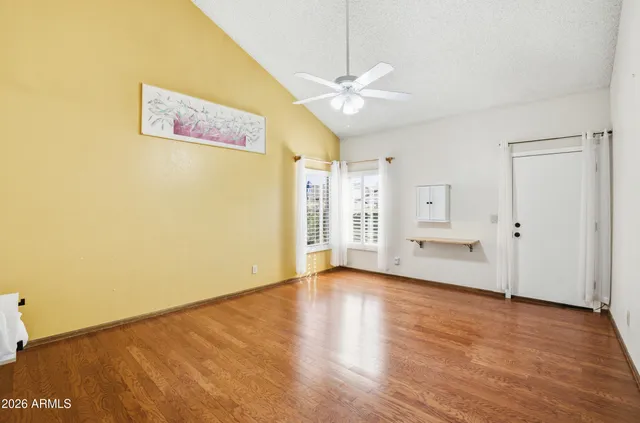a view of an empty room with wooden floor