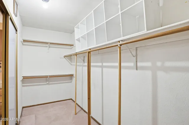 a view of walk in closet with empty racks