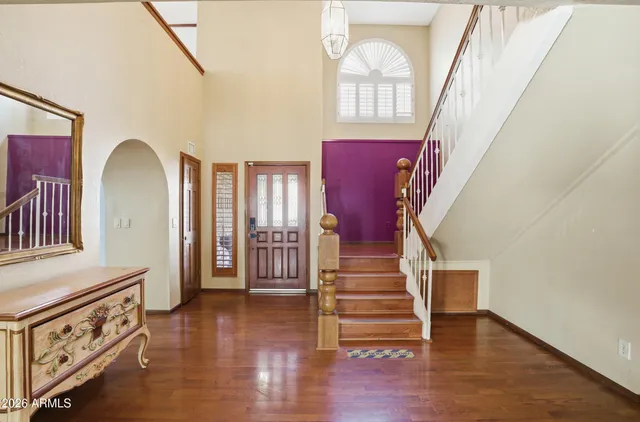 a view of an entryway with wooden floor and stairs
