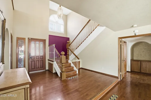 a view of front door with furniture and wooden floor