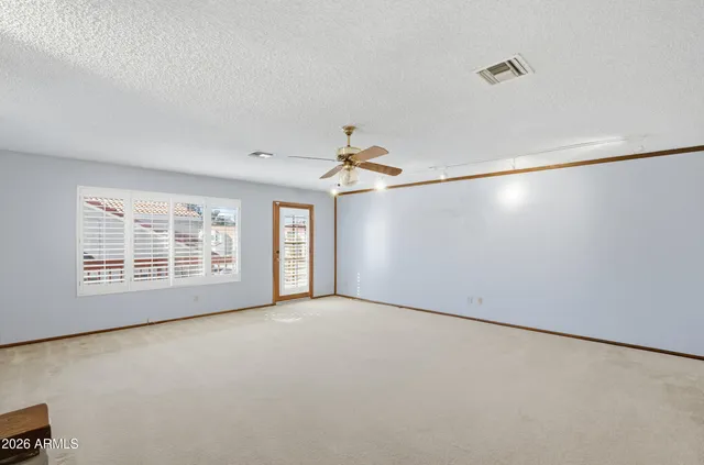 a view of an empty room with a window