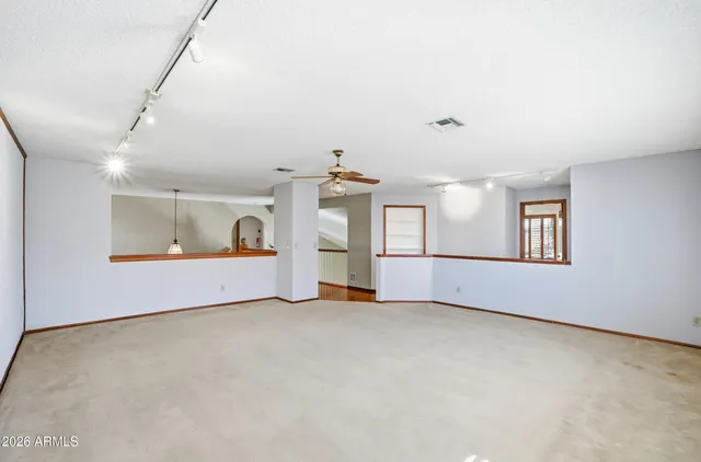 an empty room with closet and windows