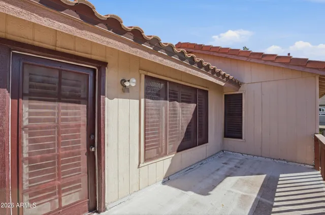 a view of a house with a door and wooden roof