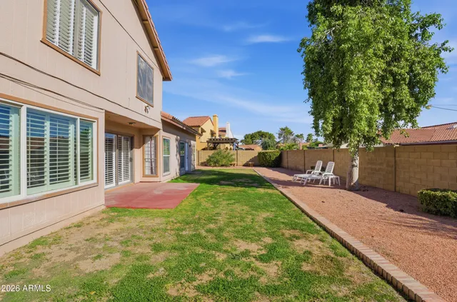 a view of backyard of house with green space
