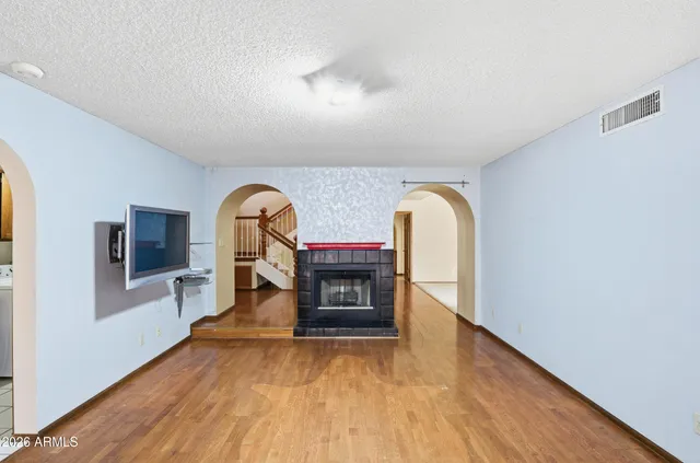 a view of living room with furniture and a fireplace