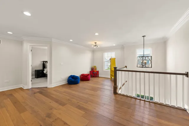 a view of a room with wooden floor and windows
