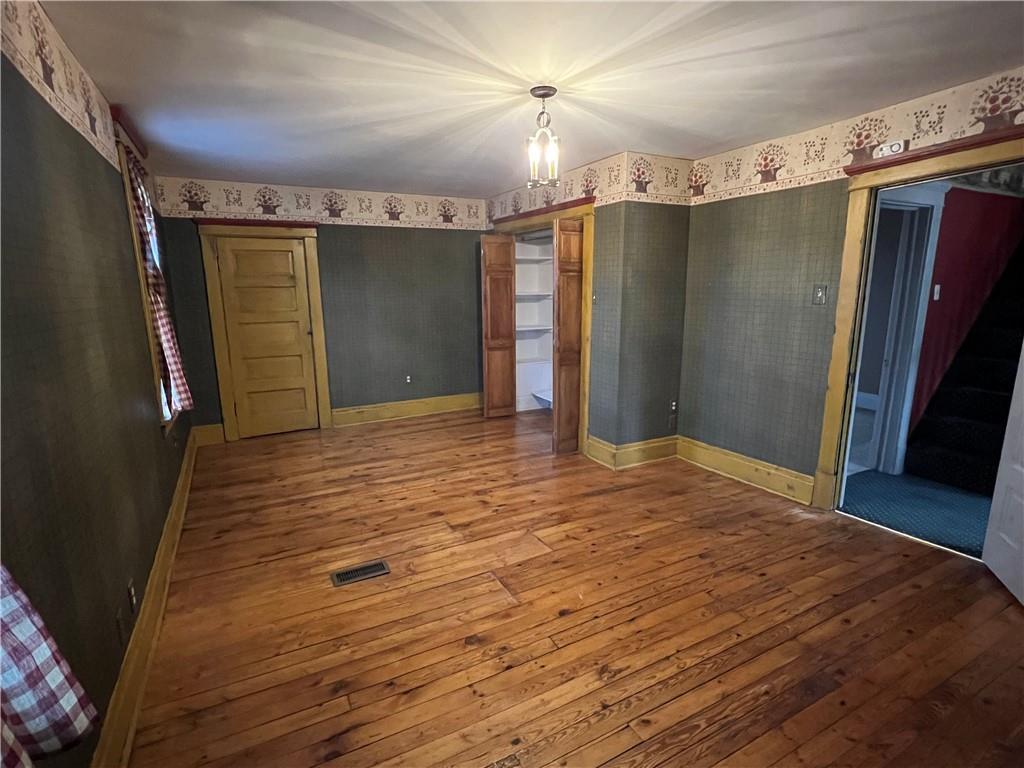 481 Heller Street Rochester, PA 15074 - Photo 12 of 24 a view of empty room with wooden floor and fan