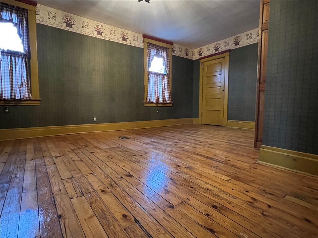 481 Heller Street Rochester, PA 15074 - Photo 13 of 24 a view of an empty room with wooden floor and a window