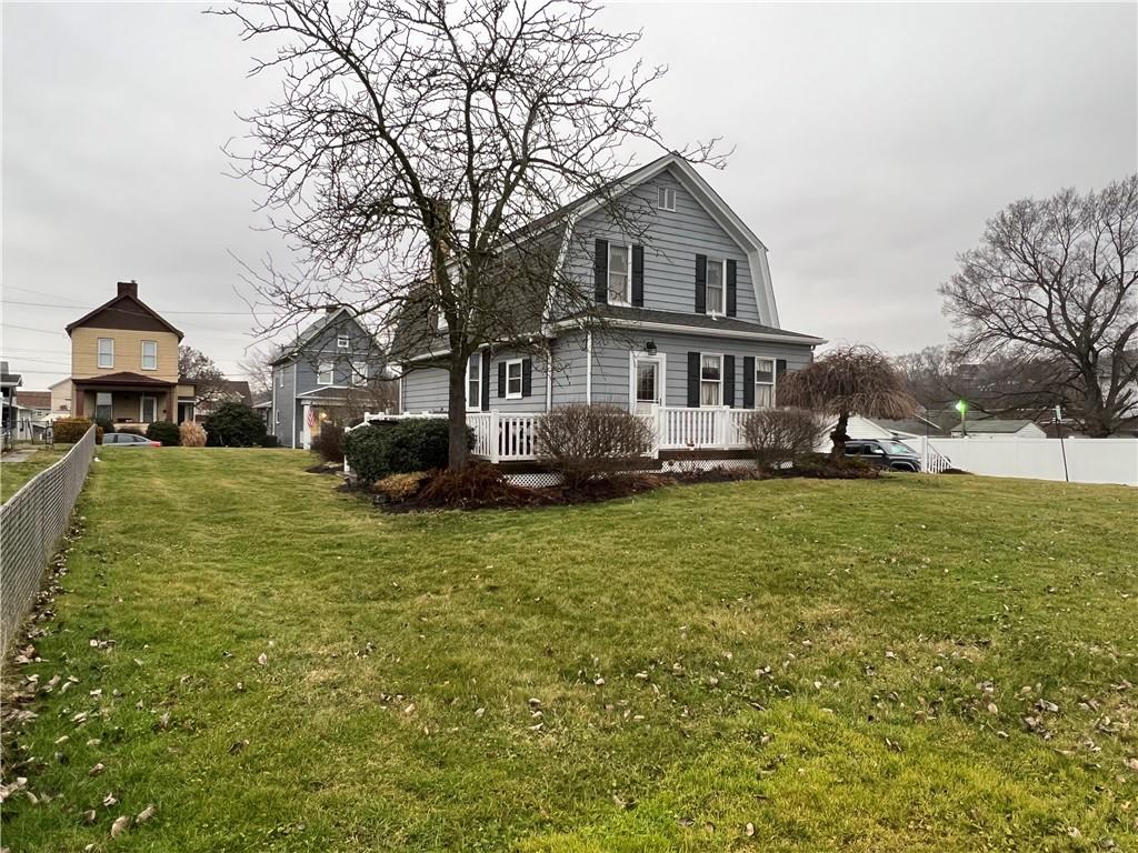 481 Heller Street Rochester, PA 15074 - Photo 22 of 24 a front view of a house with a garden and trees