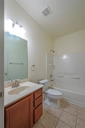 an empty room with a window and a ceiling fan