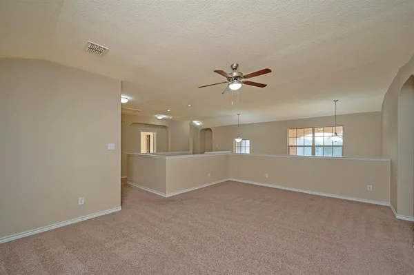 a view of a livingroom with a ceiling fan and window