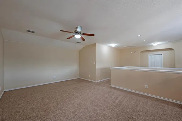 a view of a livingroom with a ceiling fan and window