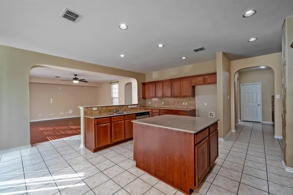 a kitchen with stainless steel appliances granite countertop a sink and cabinets