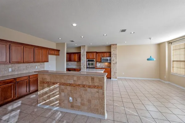 a kitchen with stainless steel appliances granite countertop a sink and cabinets