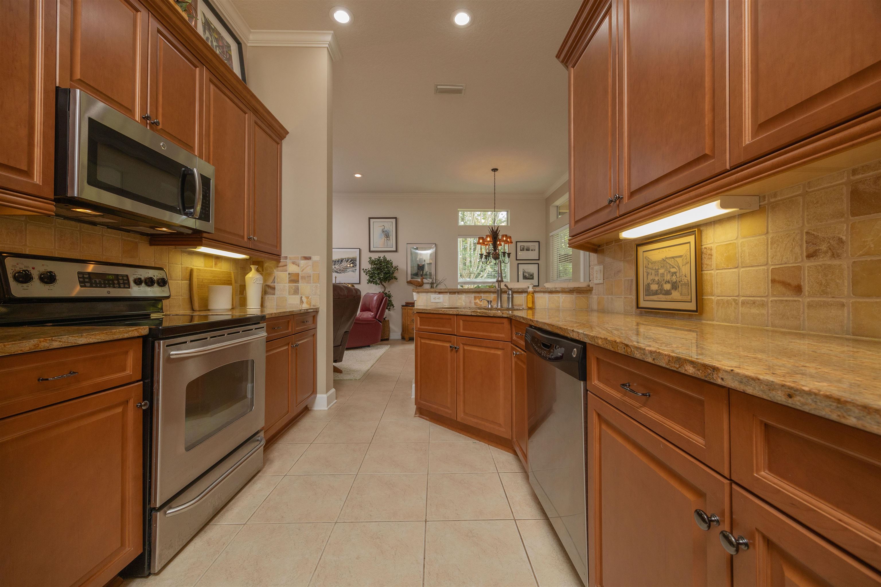 1160 Inverness Drive St. Augustine, FL 32092 - Photo 28 of 77 a kitchen with stainless steel appliances granite countertop a stove a sink and a microwave