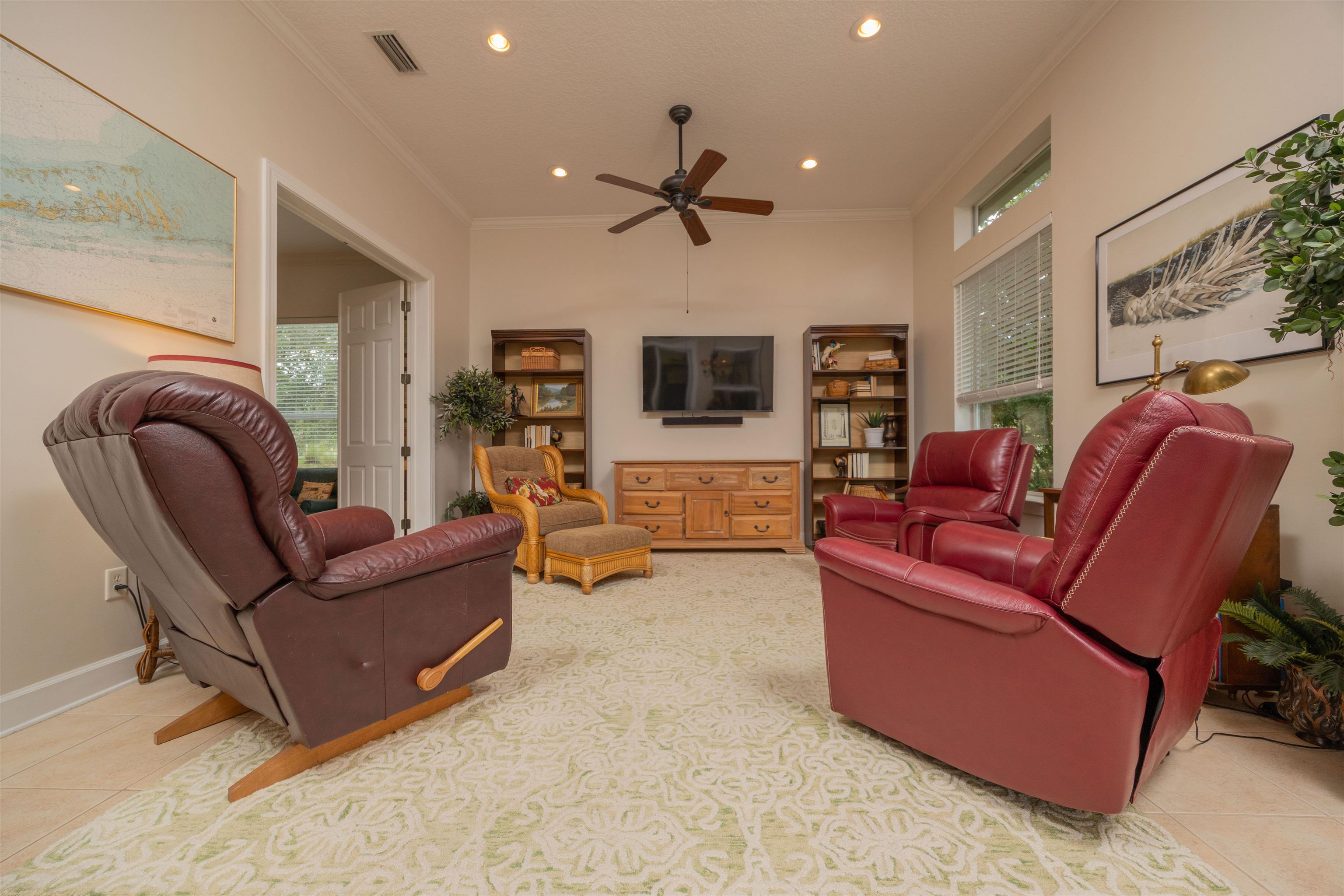 1160 Inverness Drive St. Augustine, FL 32092 - Photo 29 of 77 a living room with furniture ceiling fan and a flat screen tv
