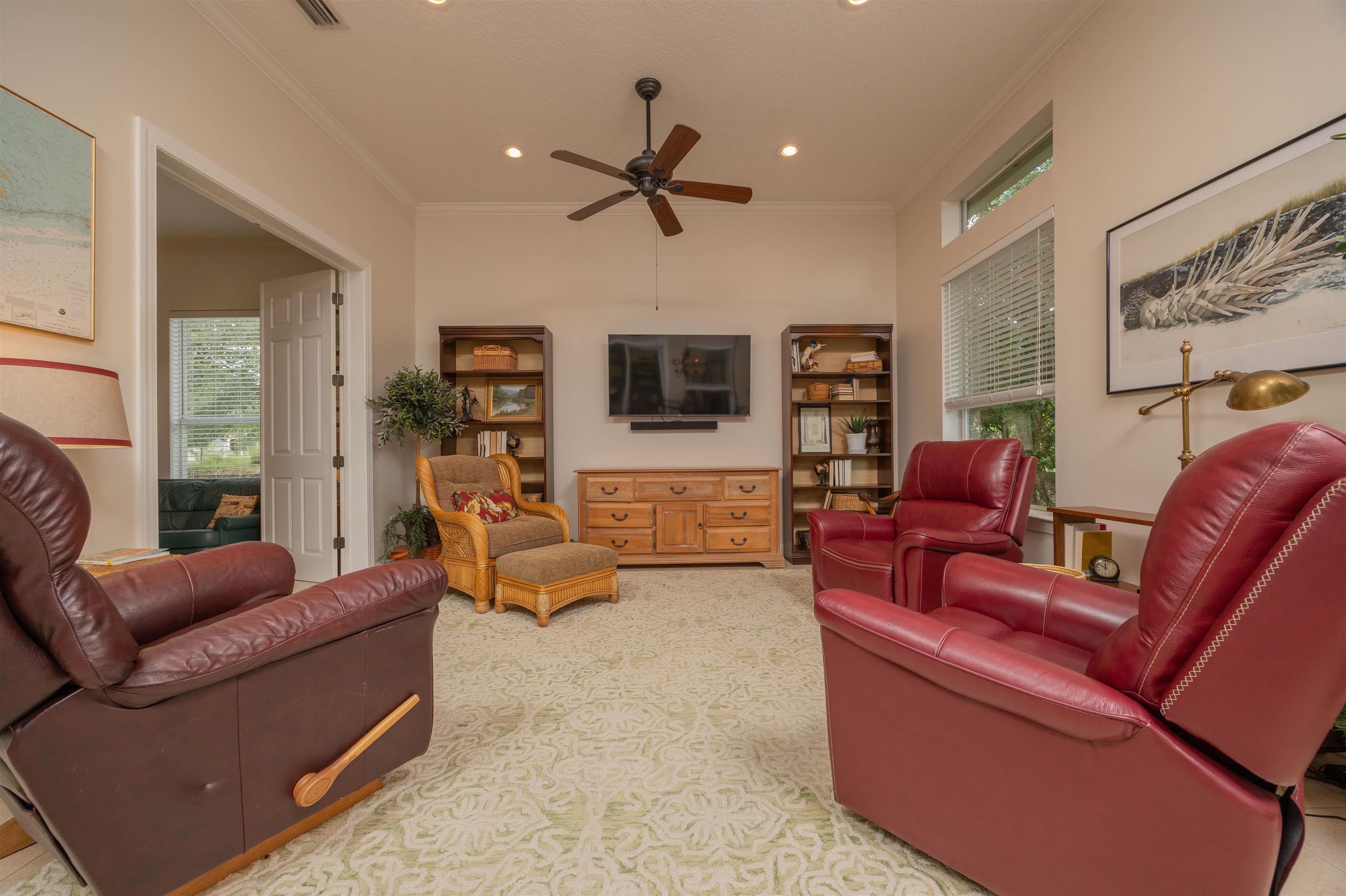 1160 Inverness Drive St. Augustine, FL 32092 - Photo 30 of 77 a living room with furniture and a flat screen tv