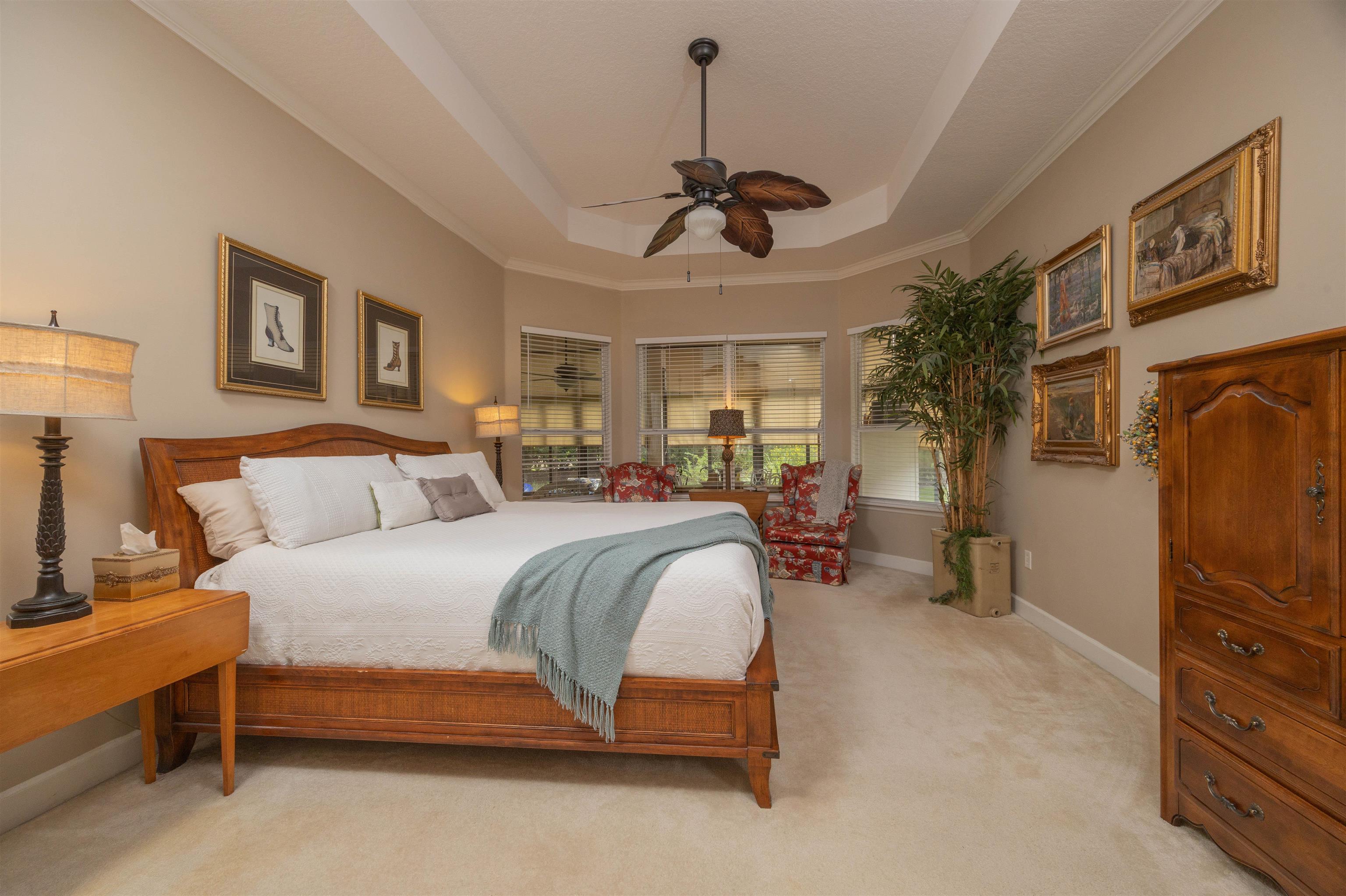 1160 Inverness Drive St. Augustine, FL 32092 - Photo 34 of 77 a spacious bedroom with a bed a window and a couch