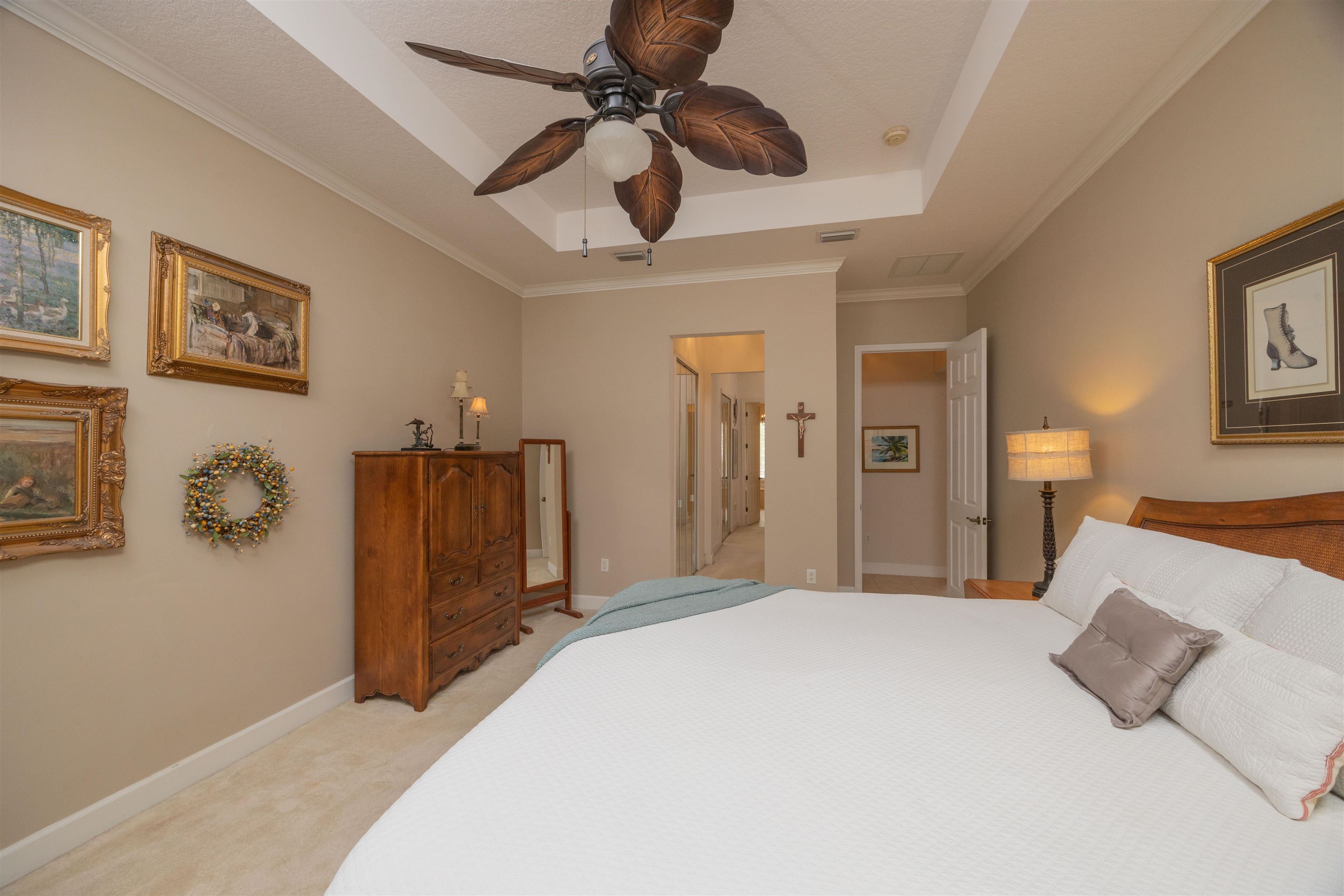 1160 Inverness Drive St. Augustine, FL 32092 - Photo 36 of 77 a bedroom with a bed and a chandelier