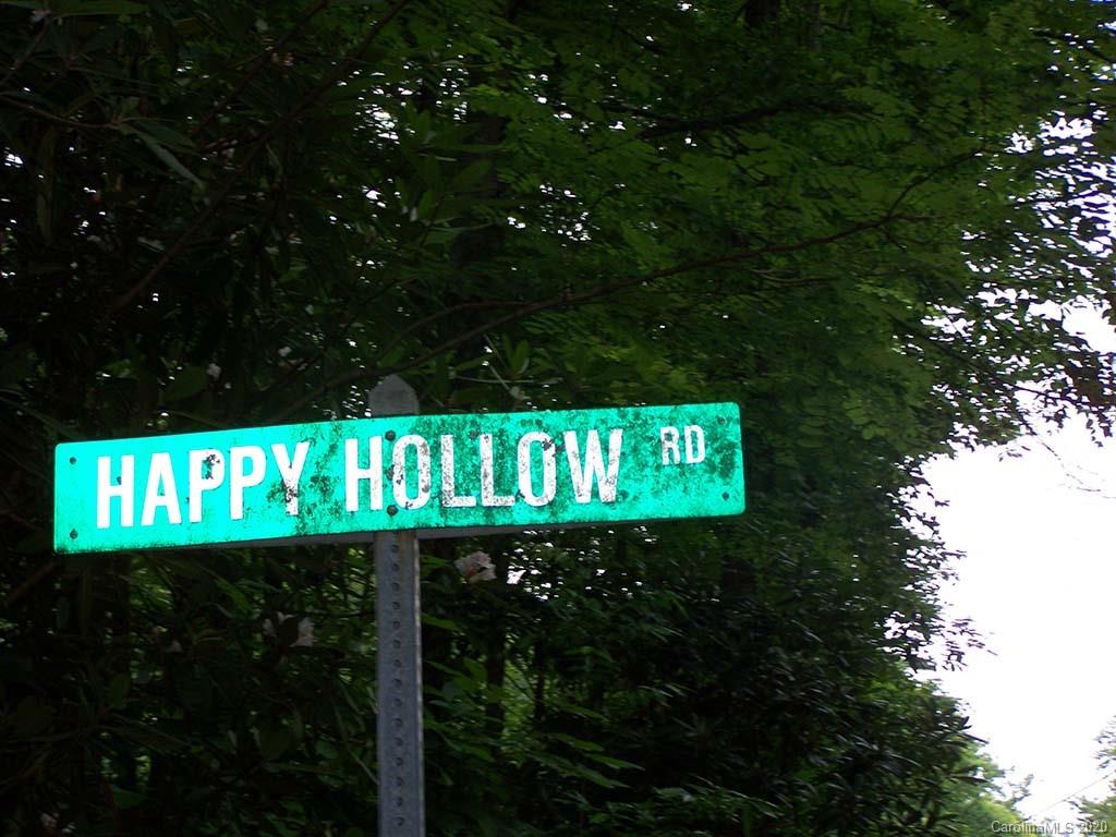 12 Happy Hollow Road, Unit 12 Clyde, NC 28721 - Photo 10 of 16 a street sign that is sitting on a tree