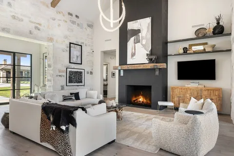 a room with stainless steel appliances kitchen island granite countertop a sink and cabinets
