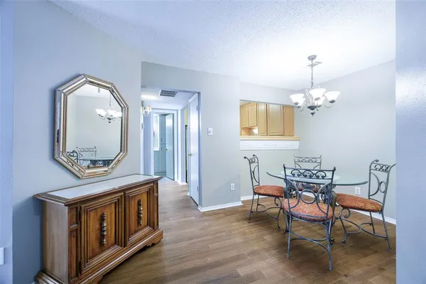 a view of a dining room with furniture and a chandelier