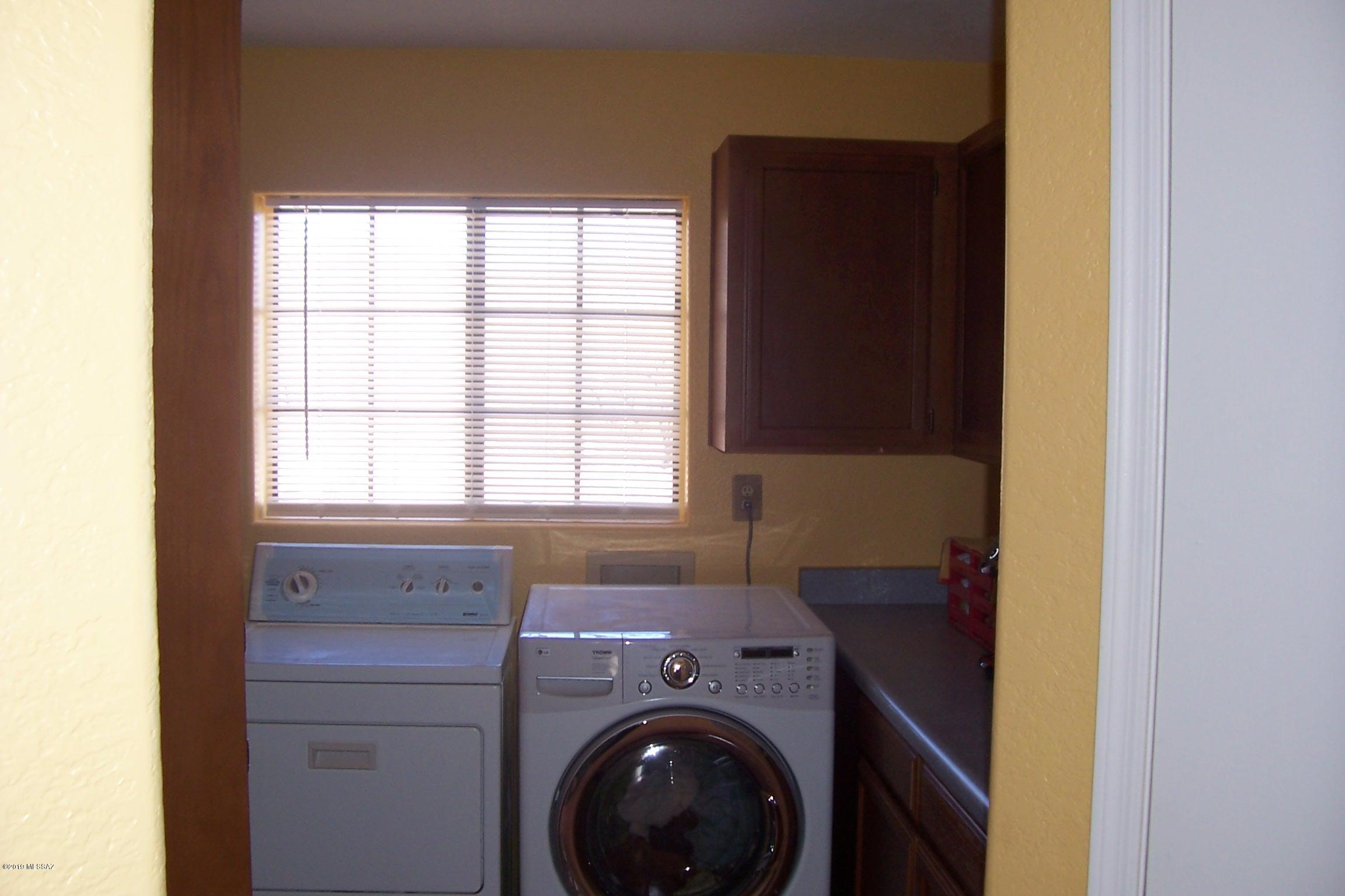 1256 Avenida Gloriosa Rio Rico, AZ 85648 - Photo 10 of 25 a utility room with dryer and washer