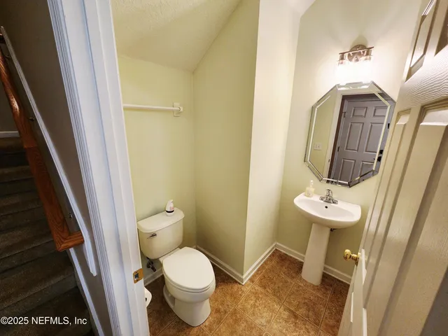 an empty room with a ceiling fan and window