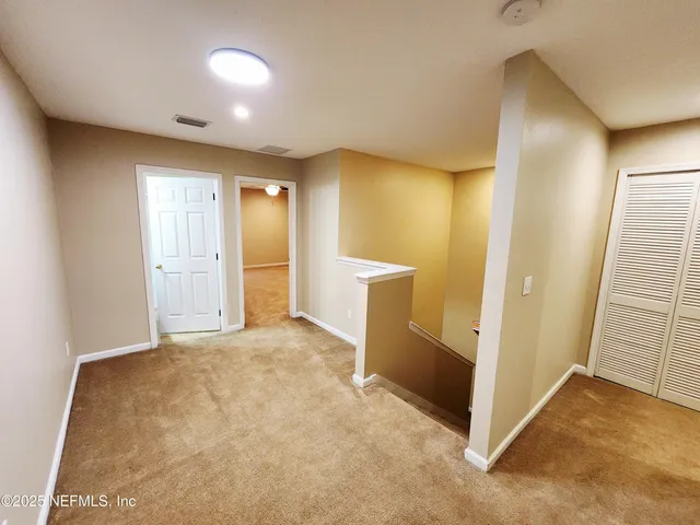 a view of a livingroom with a ceiling fan and window