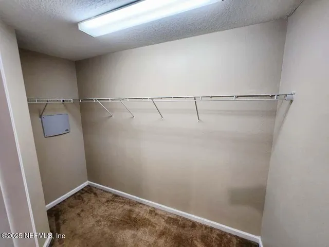 a view of a kitchen with a sink and a refrigerator