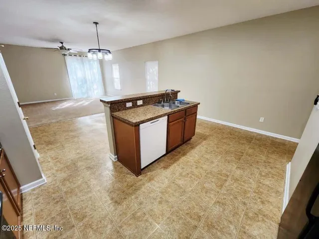 a view of a livingroom with a ceiling fan and window