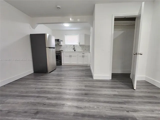 a view of a refrigerator in kitchen and wooden floor