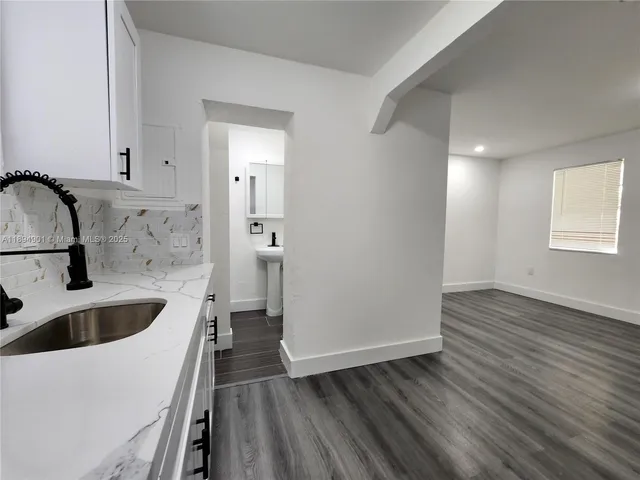 a kitchen with a sink and a refrigerator