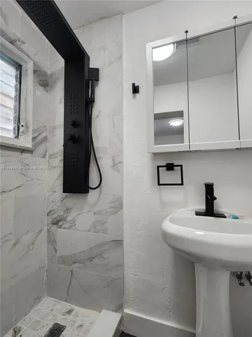 a bathroom with a sink and mirror