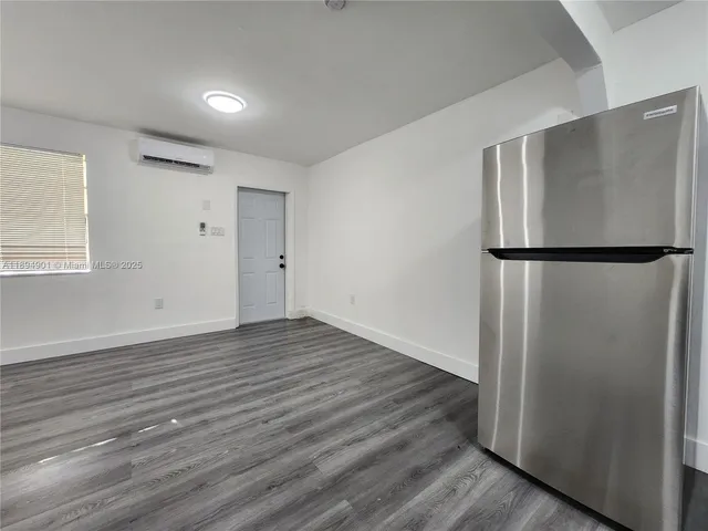a view of a refrigerator in kitchen and wooden floor