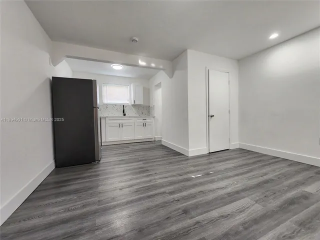 a view of a kitchen with wooden floor