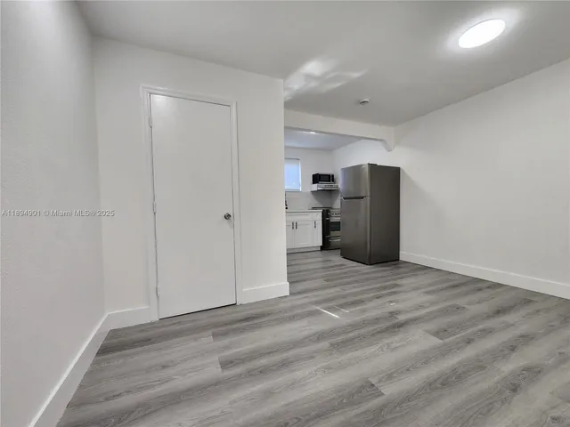 a view of a kitchen with a sink and a refrigerator