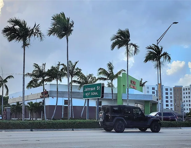 a front view of multiple houses with small garden