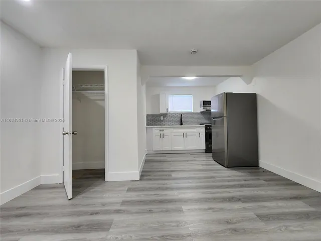a view of a kitchen with wooden floor